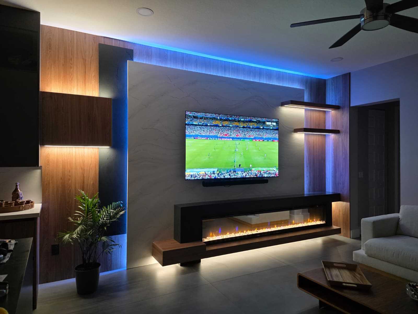 Illuminated media wall with fireplace