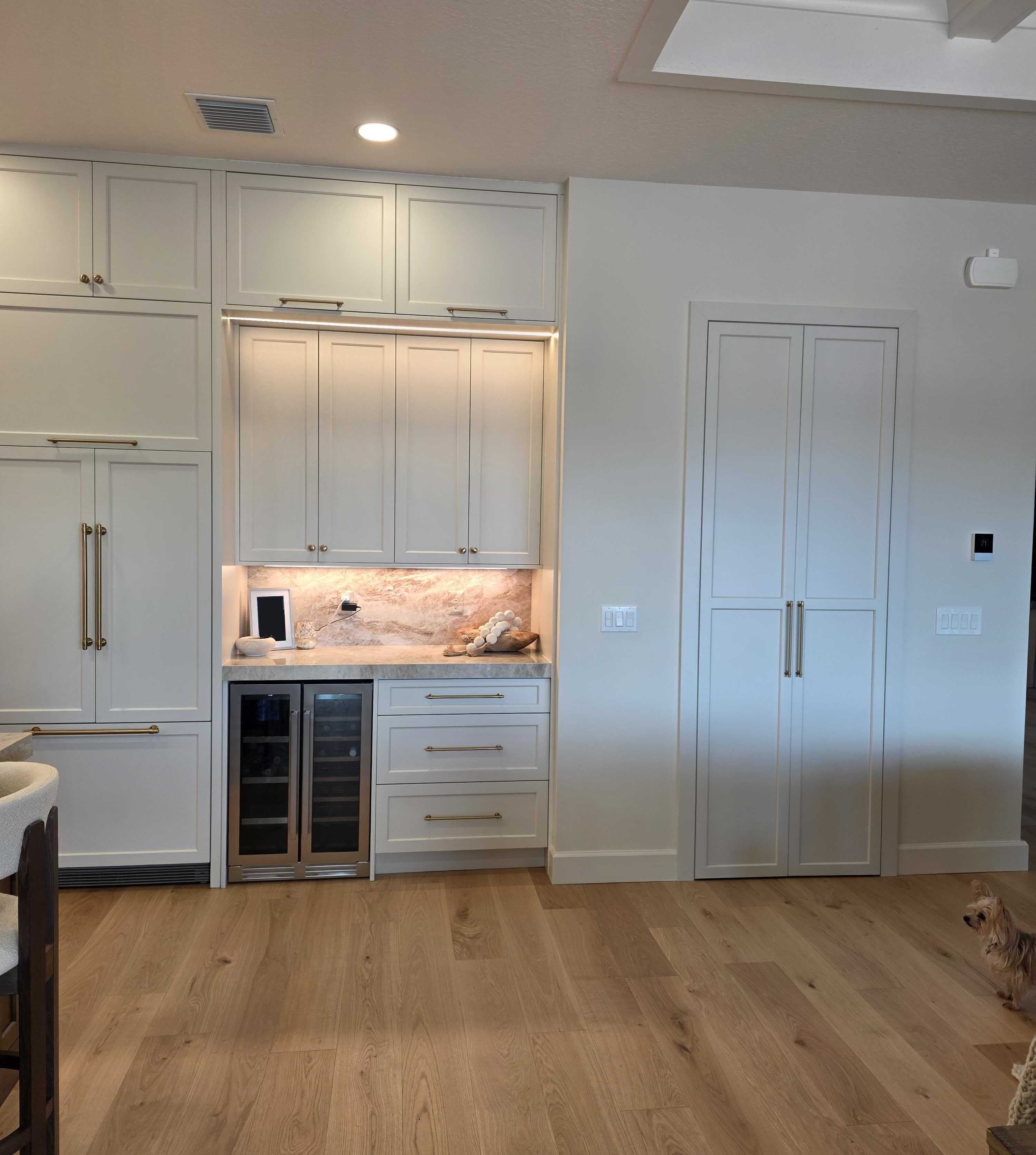 White kitchen refrigerator and beverage cabinetry
